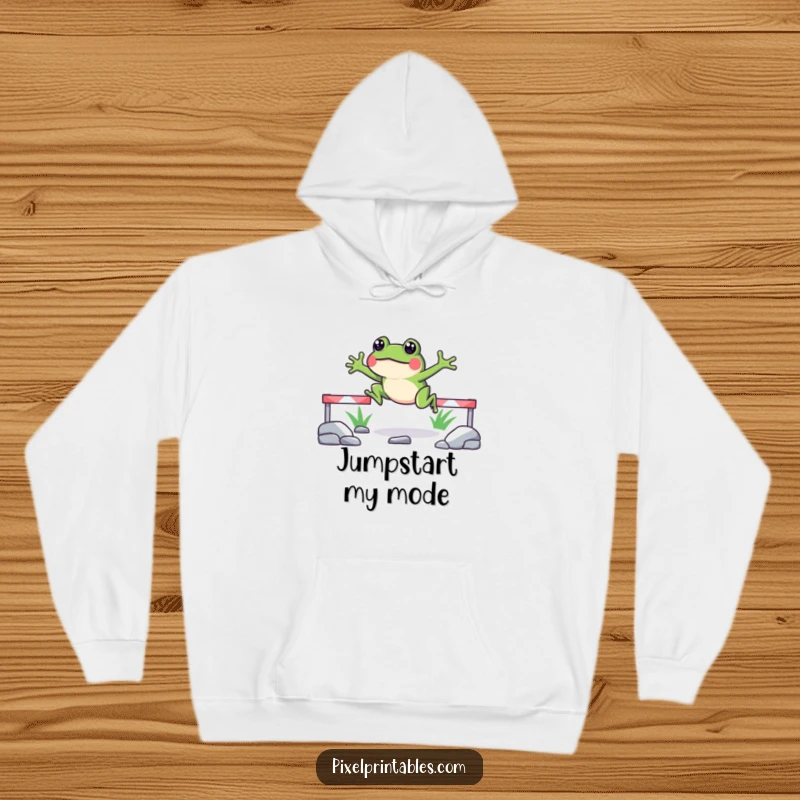 Funny pixelated frog hoodie showing a happy frog leaping over pixelated obstacles, offering warmth and a nostalgic gaming feel.